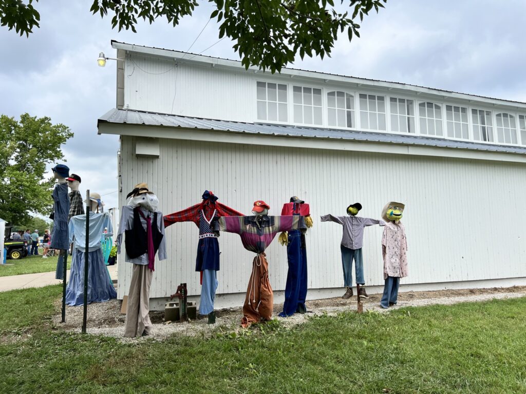 Scarecrows built by community members are displayed by the Vinland Fair barn.