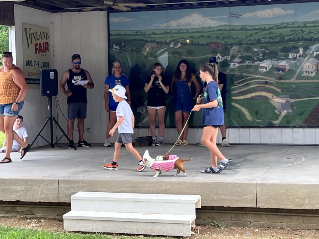 Children walk on stage during the pet parade.