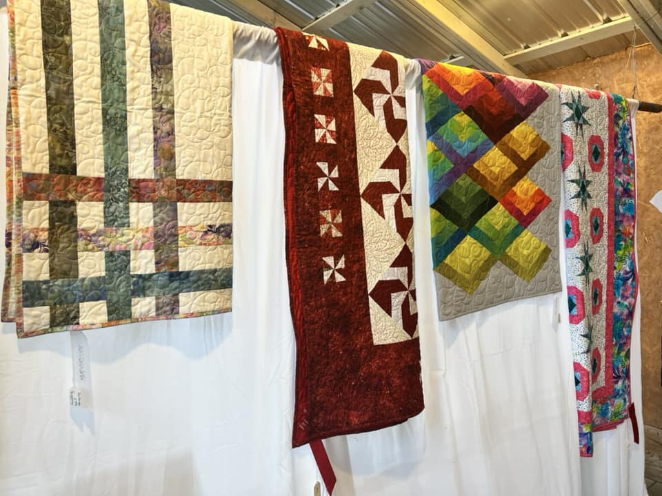 Quilts hang on display at the Vinland Fair.